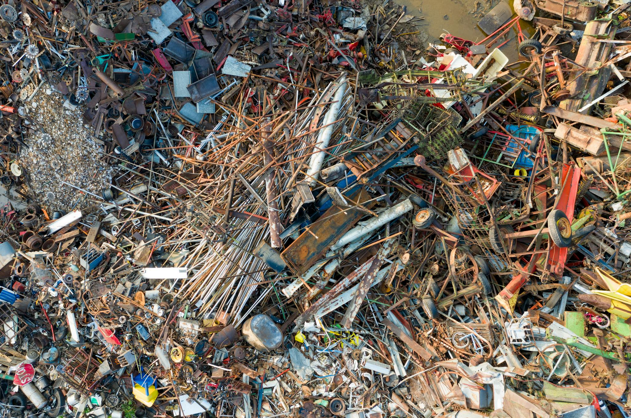 Aerial shot of scrap metal and waste gathered in a junkyard for recycling purposes.